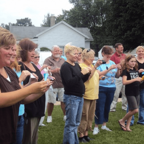 A community gathering for a live butterfly release event outside